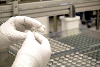 Courtesy Photo: An Si02 lab worker carefully inspects a vial at the SiO2’s laboratory located in Auburn, Alabama. The work is part of efforts for the safe and efficient distribution of a future COVID-19 vaccine.